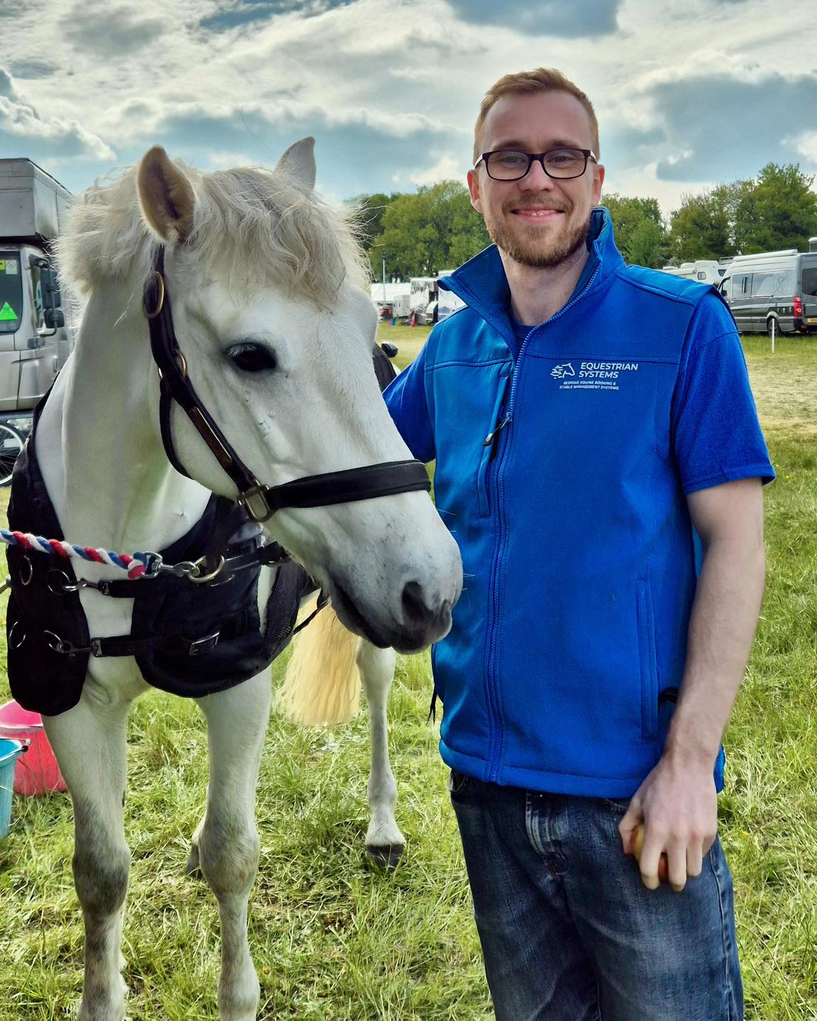 Jack Joynson, founder of Equestrian Systems with a grey horse